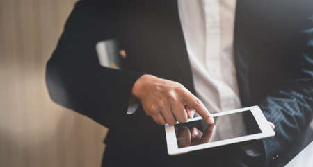 Cropped view of young businessman searching for the information for the next projectの写真素材