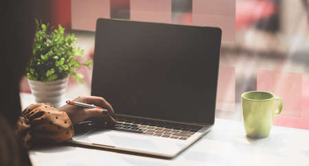 Young female freelancer working on her idea concepts in comfortable workplaceの写真素材