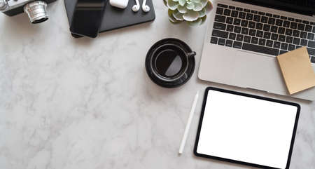 Top view of photographer's stylish workplace with laptop and office suppliesの写真素材