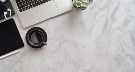 Top view of stylish work place with open laptop and decorations on marble desk backgroundの写真素材