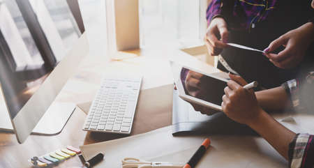 Young professional freelancer's team working on new project together in modern officeの写真素材