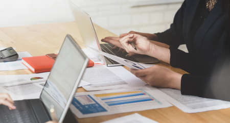 Young successful business team consulting on strategy with data and graphsの写真素材