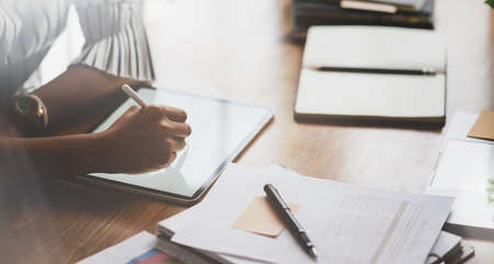 Young professional businesswoman briefing her ideas before meeting in comfortable work place with tabletの写真素材