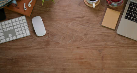 Contemporary workplace with office supplies and stationery on wooden table in home officeの写真素材