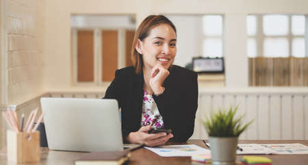 Confident young  professional asian businesswoman smiling in the office for her successfulの写真素材