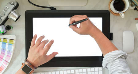 Graphic designer sketching on graphic tablet at creative workplaceの写真素材