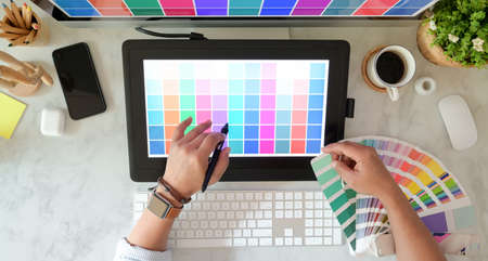 Top view of male creative graphic designer working on colour selectionの写真素材