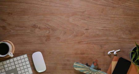 Top view of comfortable workplace with office supplies and decorations on wooden desk