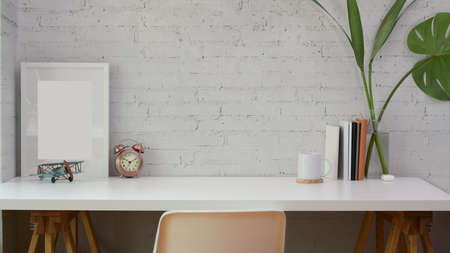 Minimal workplace with copy space and mock up frame and office suppliesの写真素材