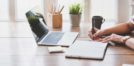 Businesswoman working with laptop in modern officeの写真素材