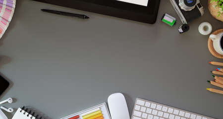 Top view of professional  photographer's workplace with office supplies on grey desk backgroundの写真素材