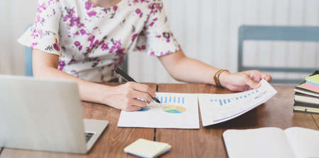 Motivated businesswoman planing the  strategy with charts and graphsの写真素材