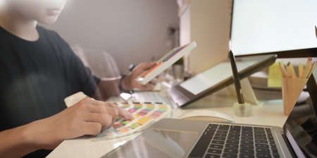 Close-up view of professional photographer working with colour swatches in modern workplaceの写真素材