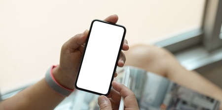 Young man holding blank screen smartphone in the relax dayの写真素材