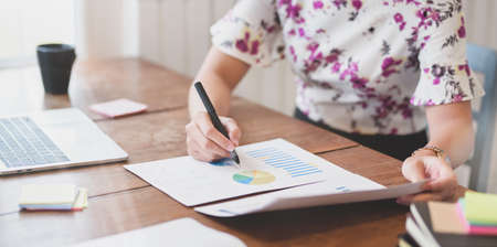 Young professional businesswoman planing the marketing strategy with charts and graphsの写真素材