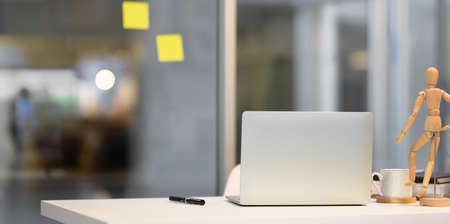 Minimal office room with laptop computer and decorationsの写真素材