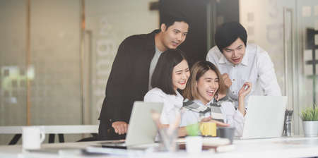 Business team feeling exited after receive the good news from successful projectの写真素材