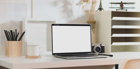 Creative photographer workplace with blank screen laptop and office suppliesの写真素材