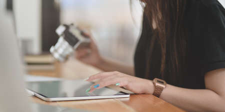 Cropped view of female graphic designer working on her project with tabletの写真素材