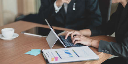 Cropped view of successful businesspeople working together with tablet in modern office roomの写真素材