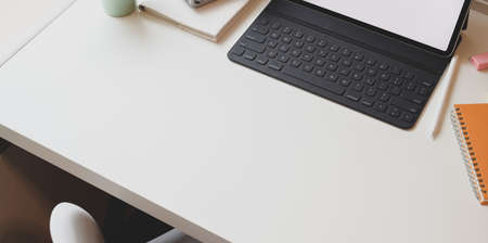 Minimal workplace with blank screen tablet and copy space on white tableの写真素材