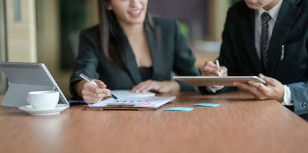 Young motivated businesspeople discussing the plan together with positive attitudeの写真素材