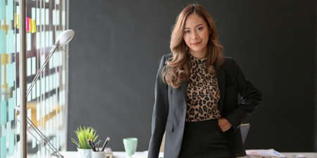 Gorgeous businesswoman looking at the camera confidently in the modern office roomの写真素材