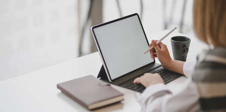 Young professional businesswoman writing her idea about the concepts in blank screen tabletの写真素材