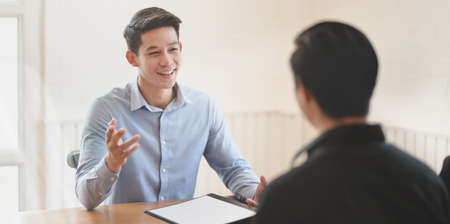 Attractive young professional businessman explaining his idea concepts to his team memberの写真素材