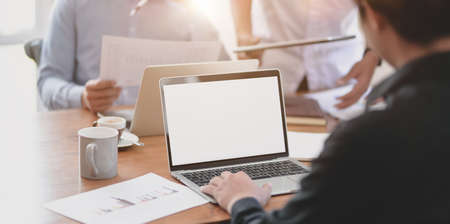 Professional business people working on their project together with laptop in the meeting room