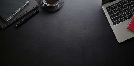 Modern workplace with laptop computer and office supplies on black lather desk background, top view with copy spaceの写真素材
