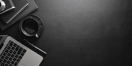 Stylish workplace with laptop computer and office supplies on black lather desk backgroundの写真素材