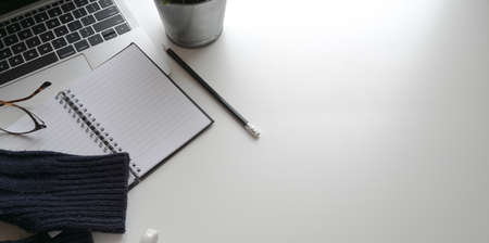 Comfortable workplace with office supplies on white table background, top view with copy spaceの写真素材