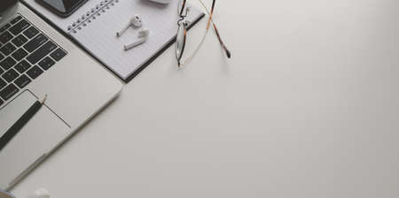 Simple workplace with office supplies on white table background, top view with copy spaceの写真素材