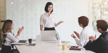 Young professional businesswoman presenting her idea about the project to her team member in the meeting roomの写真素材
