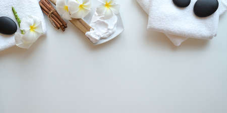 Spa therapy concept, Top view of black stones and accessories for massages on white backgroundの写真素材