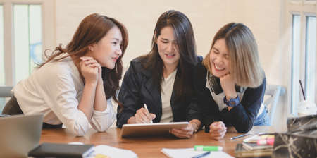 Young startup team brainstorming the strategy together in modern office room for the next project...
