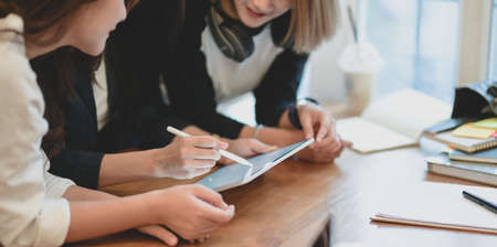 Professional startup team brainstorming the strategy together in modern office room for the next project while using tabletの写真素材