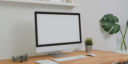 Trendy workplace with desktop computer and office supplies with decorations on wooden table