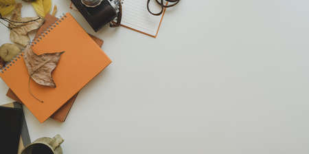 Autumn workplace concepts : Top view of minimal workplace with autumn leaves and copy space with...