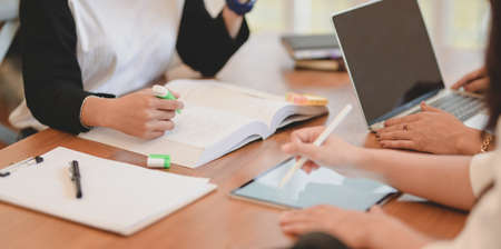 Close-up view of freelancer team discussing the plan together in modern office roomの写真素材
