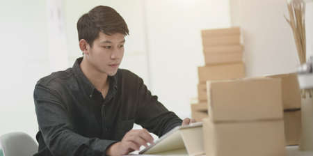 Businessman preparing shipment for deliver to customer in the office room.の写真素材