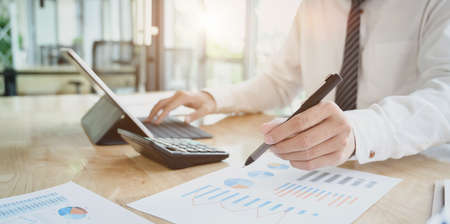 Young professional accountant preparing financial reports with charts and graphs.の写真素材