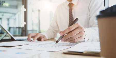 Close-up view of young professional accountant preparing financial reports with charts and graphsの写真素材