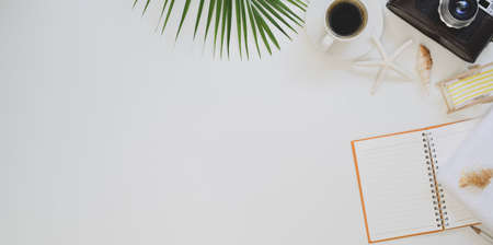 Summer beach workplace concepts : Top view of workplace with office supplies and beach decorations on white tableの写真素材