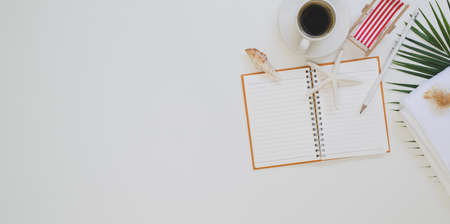 Overhead shot of blank notebook in summer beach concept workplace with copy space and office suppliesの写真素材