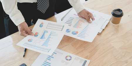 Close-up view of young professional accountant preparing financial reports with charts and graphsの写真素材