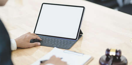 Cropped fire of young businessman analysing the marketing strategy with blank screen tabletの写真素材
