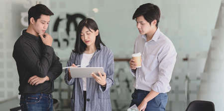 Young professional business people discussing the concepts of the new project together with tabletの写真素材