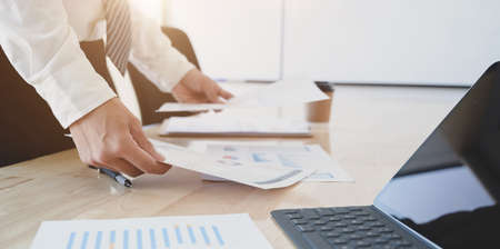 Young professional businessman preparing the financial reports for the meeting in his modern office roomの写真素材
